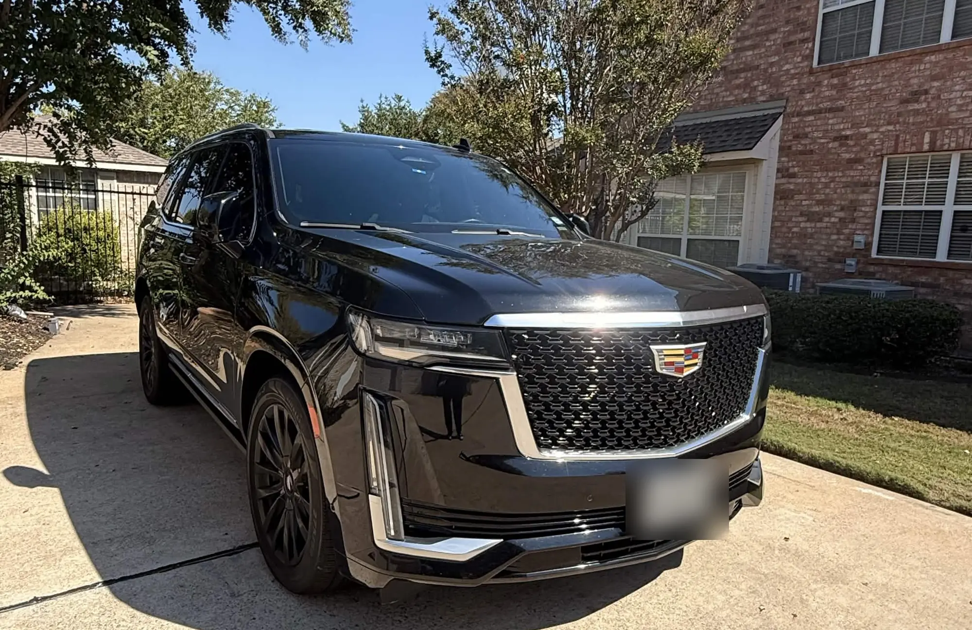 Black Cadillac Escalade parked in a Dallas driveway